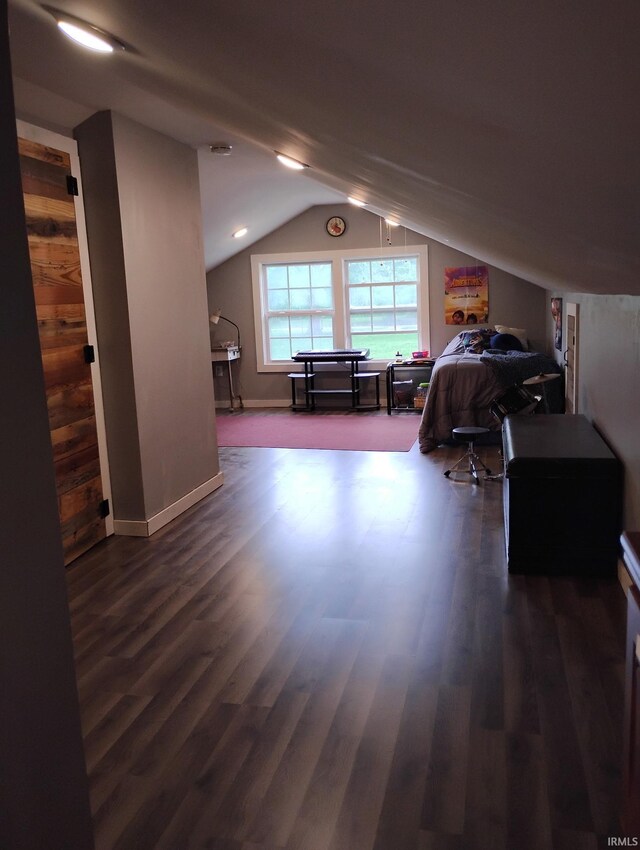 3417 Parkway S Dr, Indianapolis, IN 46201 - bedroom featuring lofted ceiling, dark wood-style flooring, baseboards, and wood walls