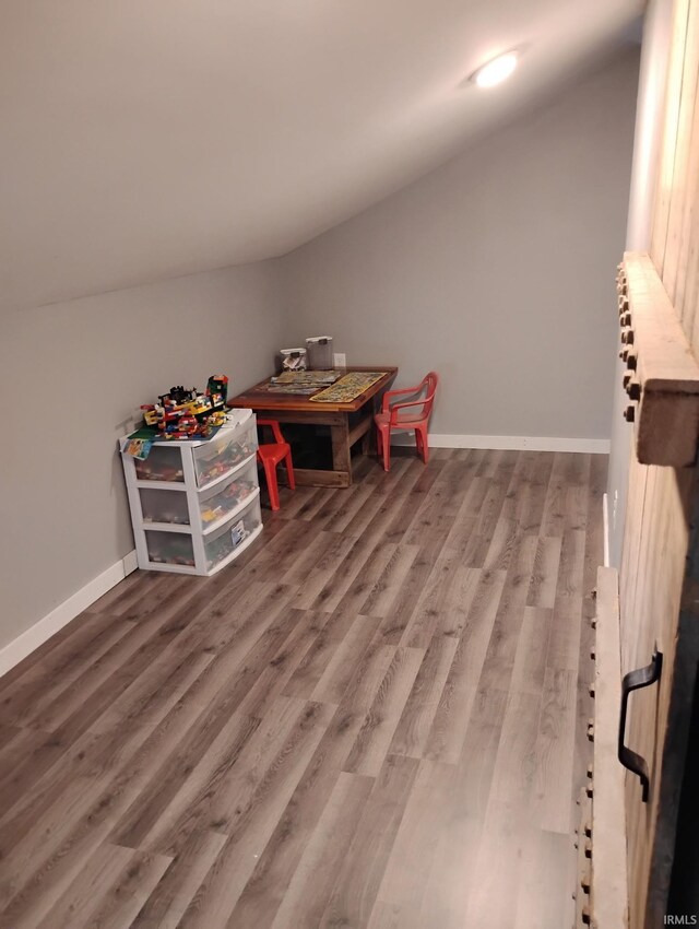 3417 Parkway S Dr, Indianapolis, IN 46201 - rec room with lofted ceiling, wood finished floors, and baseboards