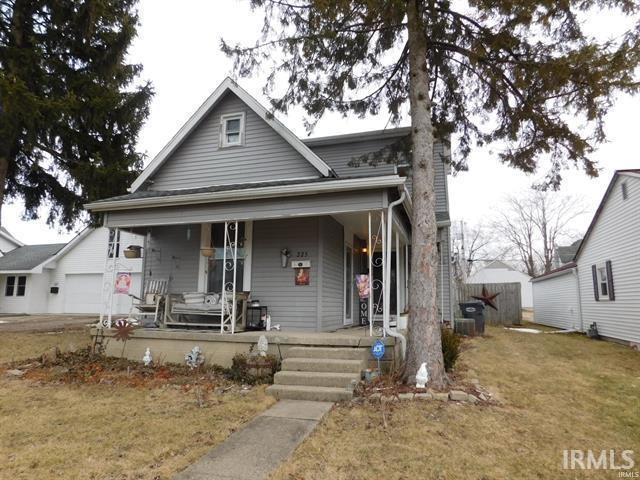 225 N Parker Ave, Albany, IN 47320 - view of front of property featuring covered porch, a front lawn, and a garage