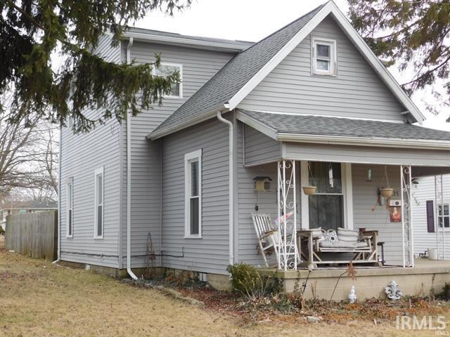 225 N Parker Ave, Albany, IN 47320 - view of front facade featuring covered porch and roof with shingles
