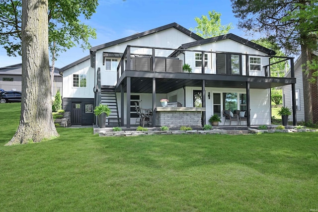 11721 N Elm Grove Dr, Syracuse, IN 46567 - back of house featuring stairs, a lawn, a patio area, and a deck