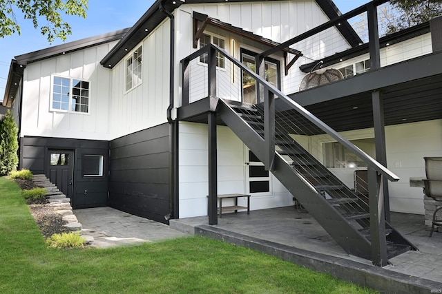 11721 N Elm Grove Dr, Syracuse, IN 46567 - rear view of property featuring stairway, board and batten siding, and a patio