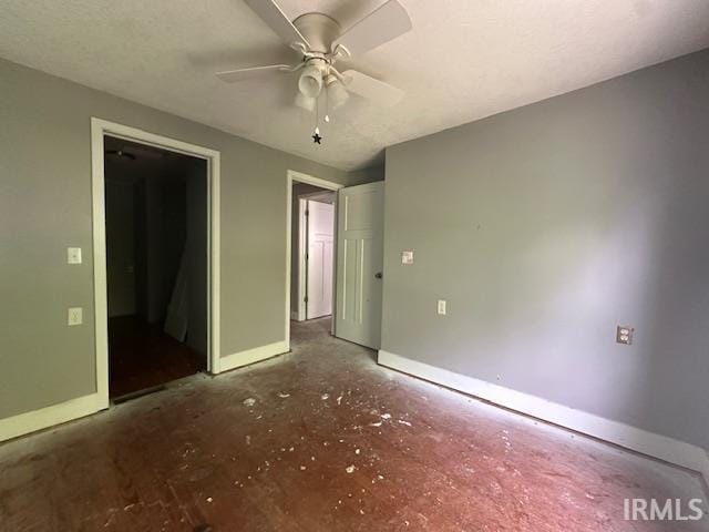 401 E Sycamore St, Converse, IN 46919 - unfurnished bedroom with unfinished concrete flooring, baseboards, and a ceiling fan