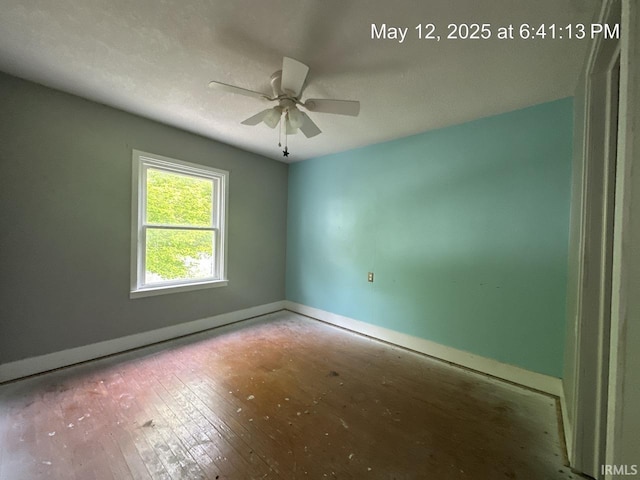 401 E Sycamore St, Converse, IN 46919 - spare room with baseboards, ceiling fan, and hardwood / wood-style floors
