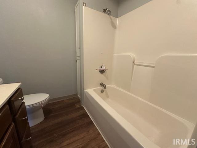 401 E Sycamore St, Converse, IN 46919 - bathroom featuring vanity, toilet, wood finished floors, shower / bath combination, and baseboards