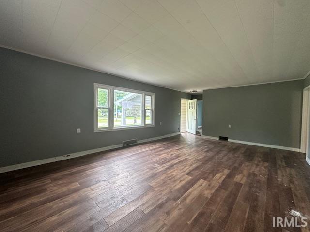 401 E Sycamore St, Converse, IN 46919 - empty room with dark wood-style flooring and baseboards