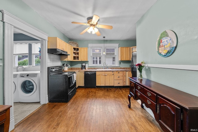 214 Tonti St, South Bend, IN 46617 - kitchen featuring black appliances, light brown cabinets, under cabinet range hood, washing machine and dryer, and dark wood finished floors