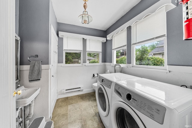 214 Tonti St, South Bend, IN 46617 - laundry room featuring a baseboard radiator and washing machine and dryer