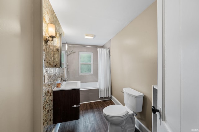 214 Tonti St, South Bend, IN 46617 - bathroom with wood finished floors, vanity, toilet, tiled shower / bath combo, and baseboards