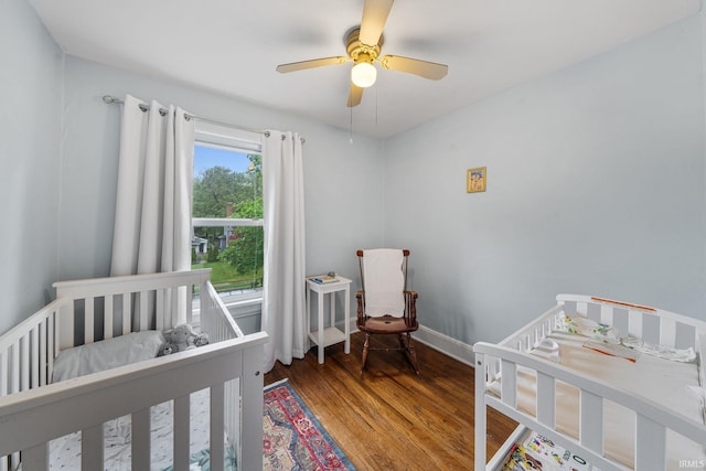 214 Tonti St, South Bend, IN 46617 - bedroom with a crib, wood finished floors, baseboards, and a ceiling fan