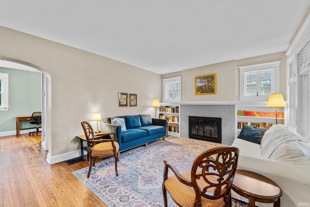 214 Tonti St, South Bend, IN 46617 - living area with arched walkways, wood finished floors, baseboards, and a fireplace