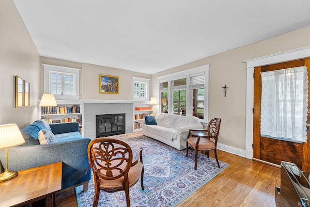 214 Tonti St, South Bend, IN 46617 - living area with healthy amount of natural light, wood finished floors, baseboards, and a brick fireplace