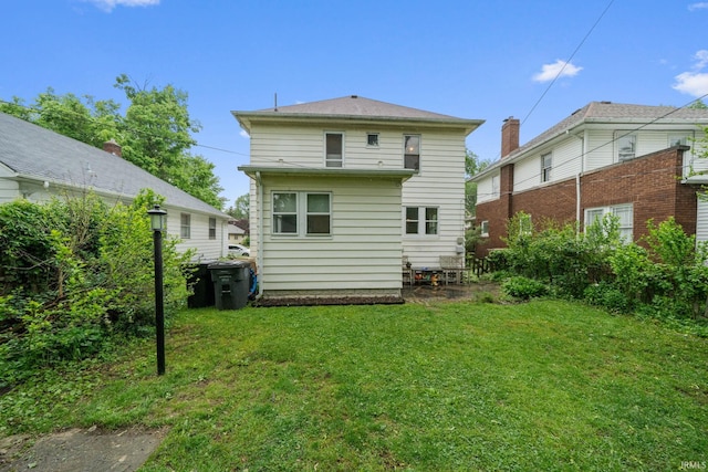 214 Tonti St, South Bend, IN 46617 - rear view of house featuring a lawn