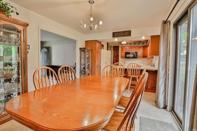 1402 Tanager Dr, Warsaw, IN 46580 - dining space with a chandelier and light tile patterned floors