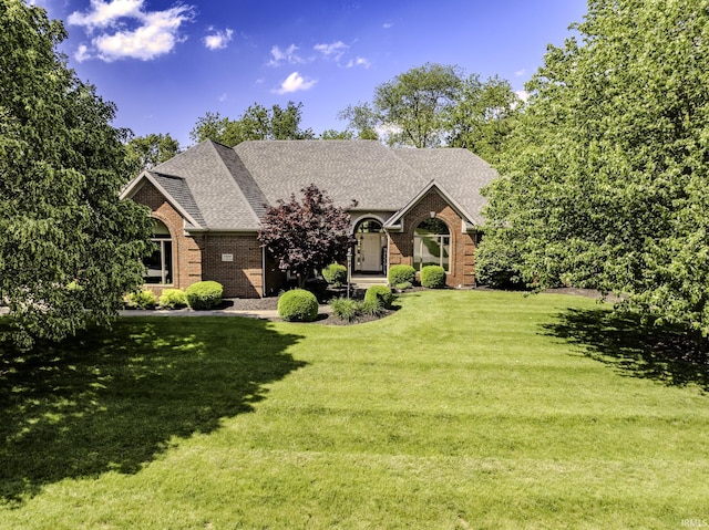 7300 W Augusta Blvd, Yorktown, IN 47396 - view of front of house with brick siding, a front yard, and a shingled roof