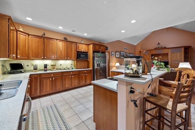 4705 Haven Ct, West Lafayette, IN 47906 - kitchen with stainless steel refrigerator with ice dispenser, black microwave, brown cabinets, light countertops, and tasteful backsplash