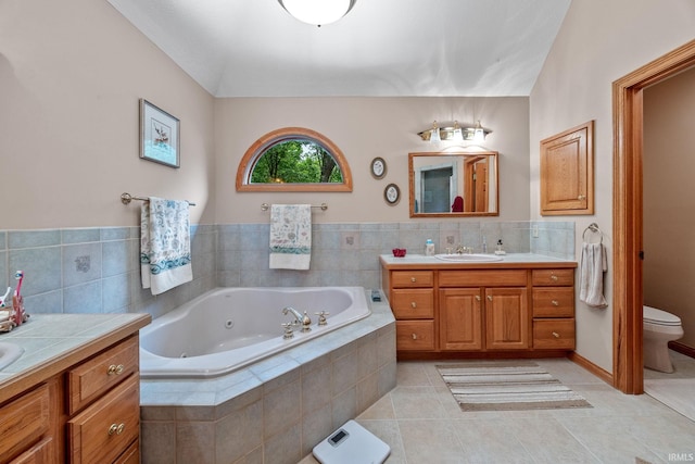 4705 Haven Ct, West Lafayette, IN 47906 - bathroom with vanity, tile patterned floors, a whirlpool tub, toilet, and tile walls
