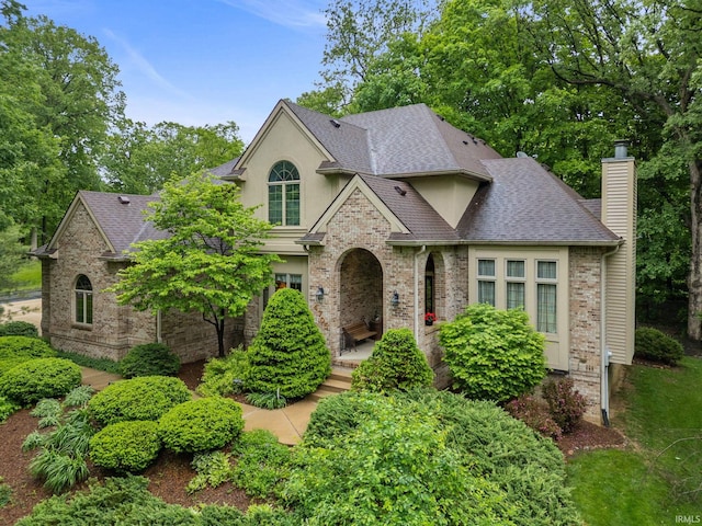 4705 Haven Ct, West Lafayette, IN 47906 - view of front of home featuring a shingled roof, a chimney, brick siding, and stucco siding