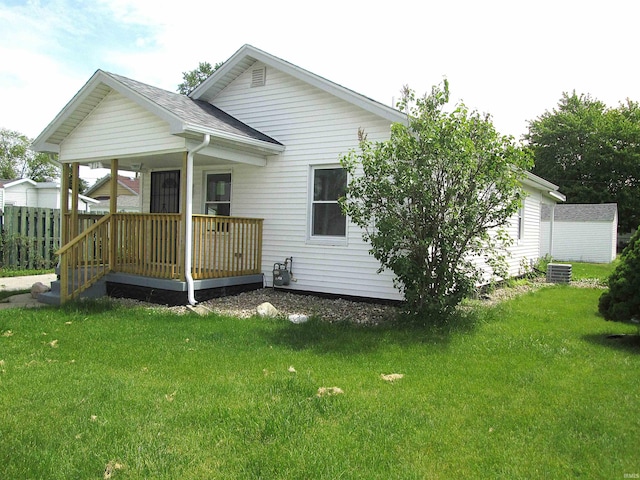 712 Hubbard St, Mishawaka, IN 46544 - back of house featuring a porch, a lawn, central AC, and a shingled roof