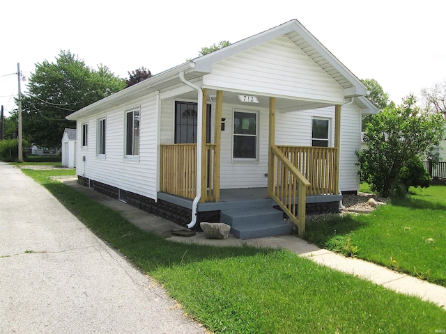712 Hubbard St, Mishawaka, IN 46544 - view of front of house with a front yard and a porch