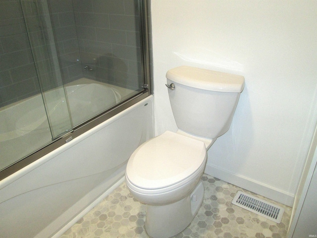 712 Hubbard St, Mishawaka, IN 46544 - bathroom with enclosed tub / shower combo, toilet, baseboards, and tile patterned floors