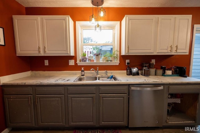 509 N Mckenzie St, Muncie, IN 47304 - kitchen with dishwasher, a sink, white cabinets, and a textured ceiling