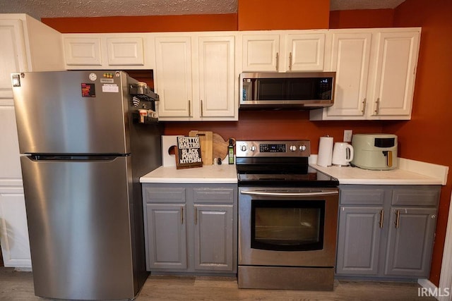 509 N Mckenzie St, Muncie, IN 47304 - kitchen featuring appliances with stainless steel finishes, gray cabinetry, and light countertops