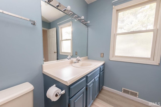 1005 S Carleton Ct, Bloomington, IN 47401 - half bath with toilet, vanity, wood finished floors, and baseboards