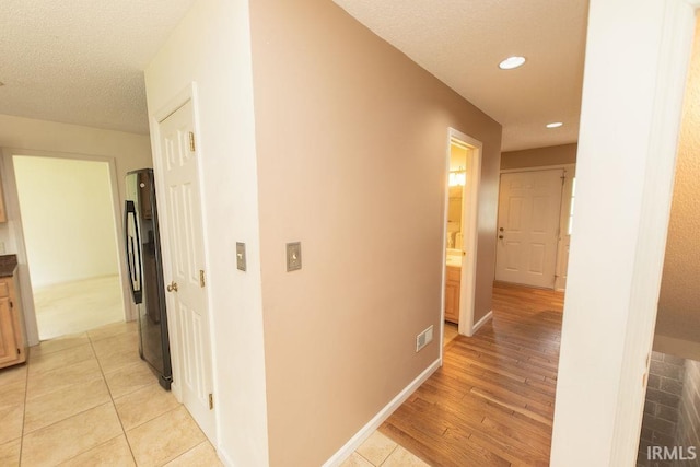 1005 S Carleton Ct, Bloomington, IN 47401 - hallway featuring recessed lighting, a textured ceiling, and light wood-style flooring