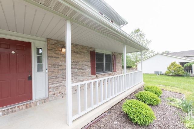 1005 S Carleton Ct, Bloomington, IN 47401 - view of exterior entry with covered porch, brick siding, and a yard