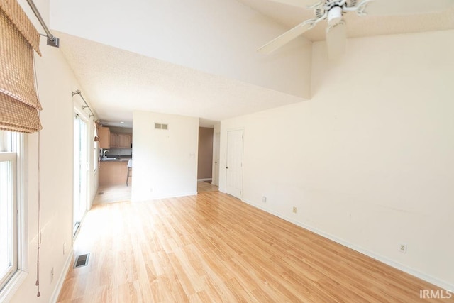 1005 S Carleton Ct, Bloomington, IN 47401 - unfurnished living room with light wood-style floors, a ceiling fan, a sink, and baseboards