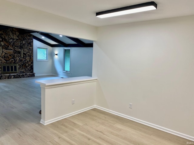 4605 Merriam Park Dr, Fort Wayne, IN 46816 - basement with light wood-style floors, baseboards, and a stone fireplace