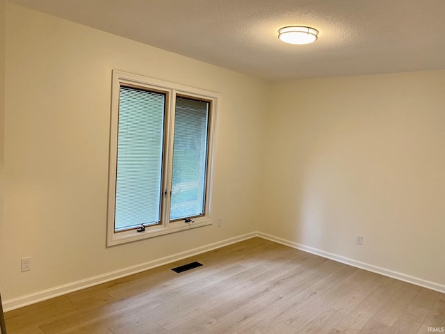 4605 Merriam Park Dr, Fort Wayne, IN 46816 - spare room with light wood-type flooring, baseboards, and a textured ceiling