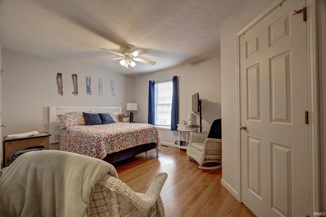 3491 S Oaklawn Cir, Bloomington, IN 47401 - bedroom featuring light wood-style flooring, a ceiling fan, and baseboards