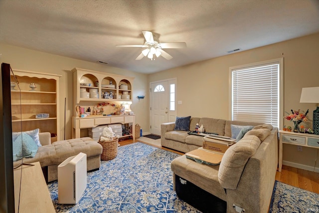 3491 S Oaklawn Cir, Bloomington, IN 47401 - living room featuring ceiling fan, wood finished floors, and baseboards