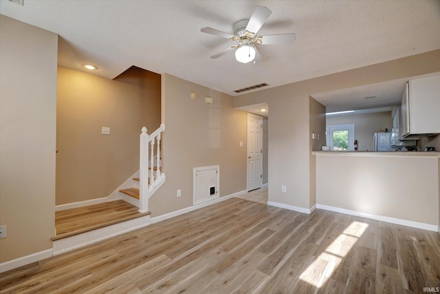 3425 S Oaklawn Cir, Bloomington, IN 47401 - unfurnished living room with light wood finished floors, stairway, ceiling fan, baseboards, and recessed lighting