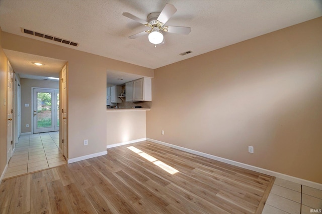 3425 S Oaklawn Cir, Bloomington, IN 47401 - spare room with ceiling fan, a textured ceiling, light wood-type flooring, and baseboards