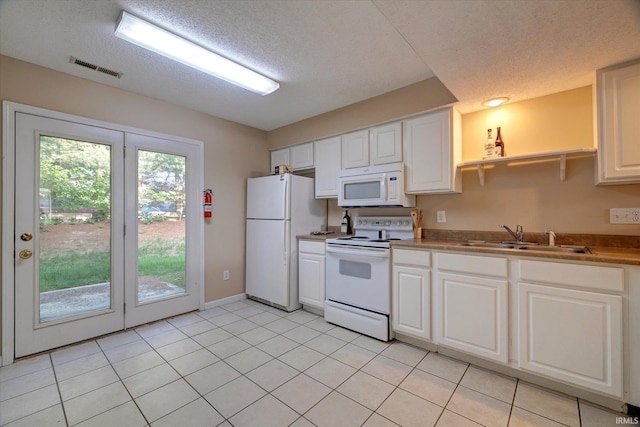 3425 S Oaklawn Cir, Bloomington, IN 47401 - kitchen featuring white appliances, a sink, a textured ceiling, white cabinets, and baseboards