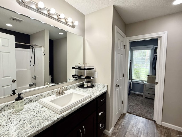 310 Main St, Lagro, IN 46941 - full bathroom with vanity, toilet, shower / bath combination, wood finished floors, and baseboards