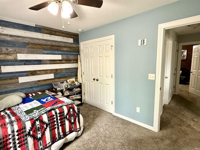 310 Main St, Lagro, IN 46941 - bedroom with wooden walls, carpet, and a ceiling fan