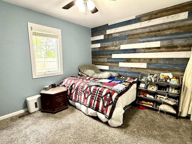 310 Main St, Lagro, IN 46941 - bedroom with carpet, wooden walls, and a ceiling fan