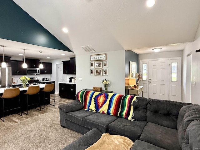 310 Main St, Lagro, IN 46941 - living room with light wood finished floors, vaulted ceiling, and recessed lighting