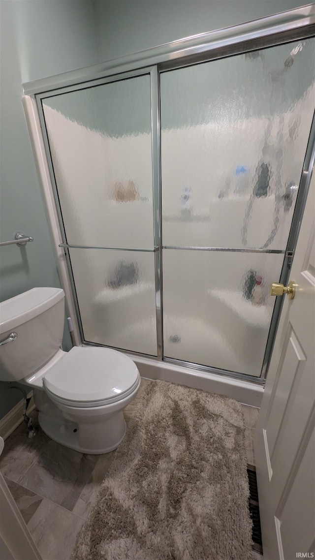 5728 Bell Tower Ln, Fort Wayne, IN 46815 - bathroom featuring toilet, a stall shower, and baseboards