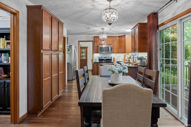 821 Lagrange St, West Lafayette, IN 47906 - dining room featuring a chandelier, dark wood-type flooring, and a textured ceiling