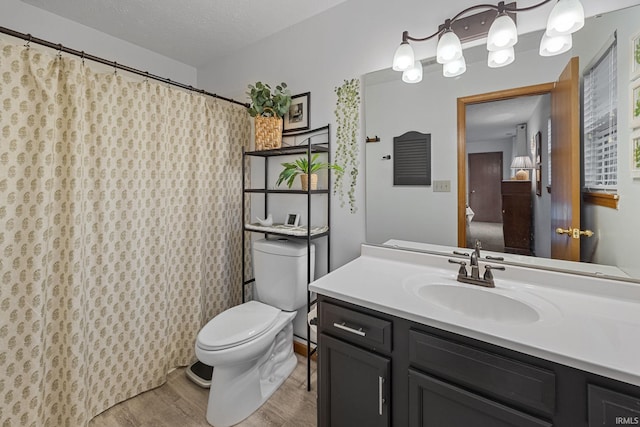 821 Lagrange St, West Lafayette, IN 47906 - bathroom with toilet, vanity, wood finished floors, and a shower with curtain