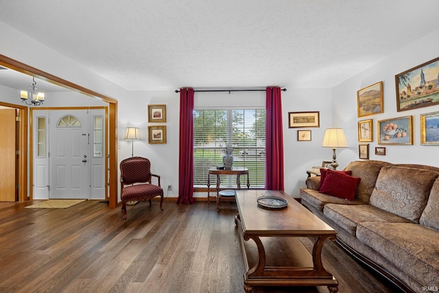 821 Lagrange St, West Lafayette, IN 47906 - living area with wood finished floors, a chandelier, a textured ceiling, and baseboards