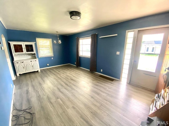 589 2nd St NW, Linton, IN 47441 - unfurnished living room featuring wood finished floors and baseboards