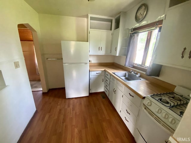 589 2nd St NW, Linton, IN 47441 - kitchen with white appliances, dark wood finished floors, a sink, light countertops, and white cabinetry