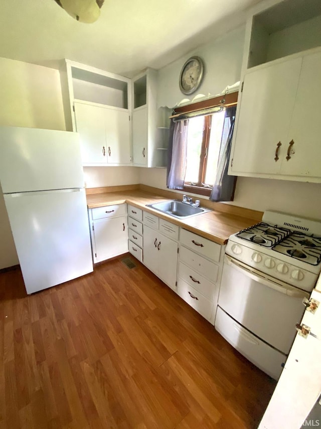 589 2nd St NW, Linton, IN 47441 - kitchen with white appliances, a sink, open shelves, dark wood finished floors, and light countertops
