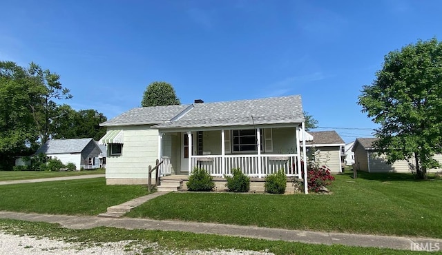 589 2nd St NW, Linton, IN 47441 - bungalow-style house with a porch, a front lawn, and roof with shingles